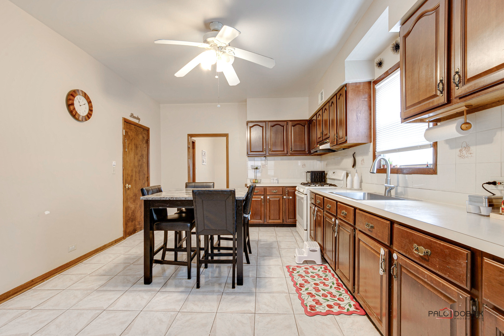 47 Prairie Avenue, Unit 1 Highwood, IL 60040 - Photo 11 of 20 a kitchen with a dining table chairs and white cabinets