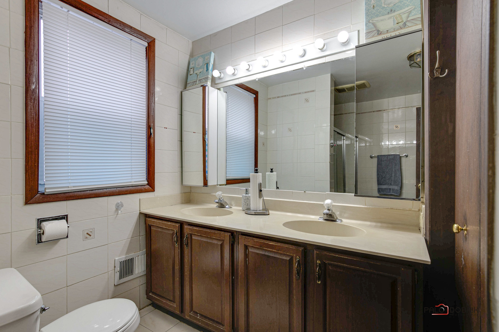 47 Prairie Avenue, Unit 1 Highwood, IL 60040 - Photo 13 of 20 a bathroom with a double vanity sink mirror and toilet