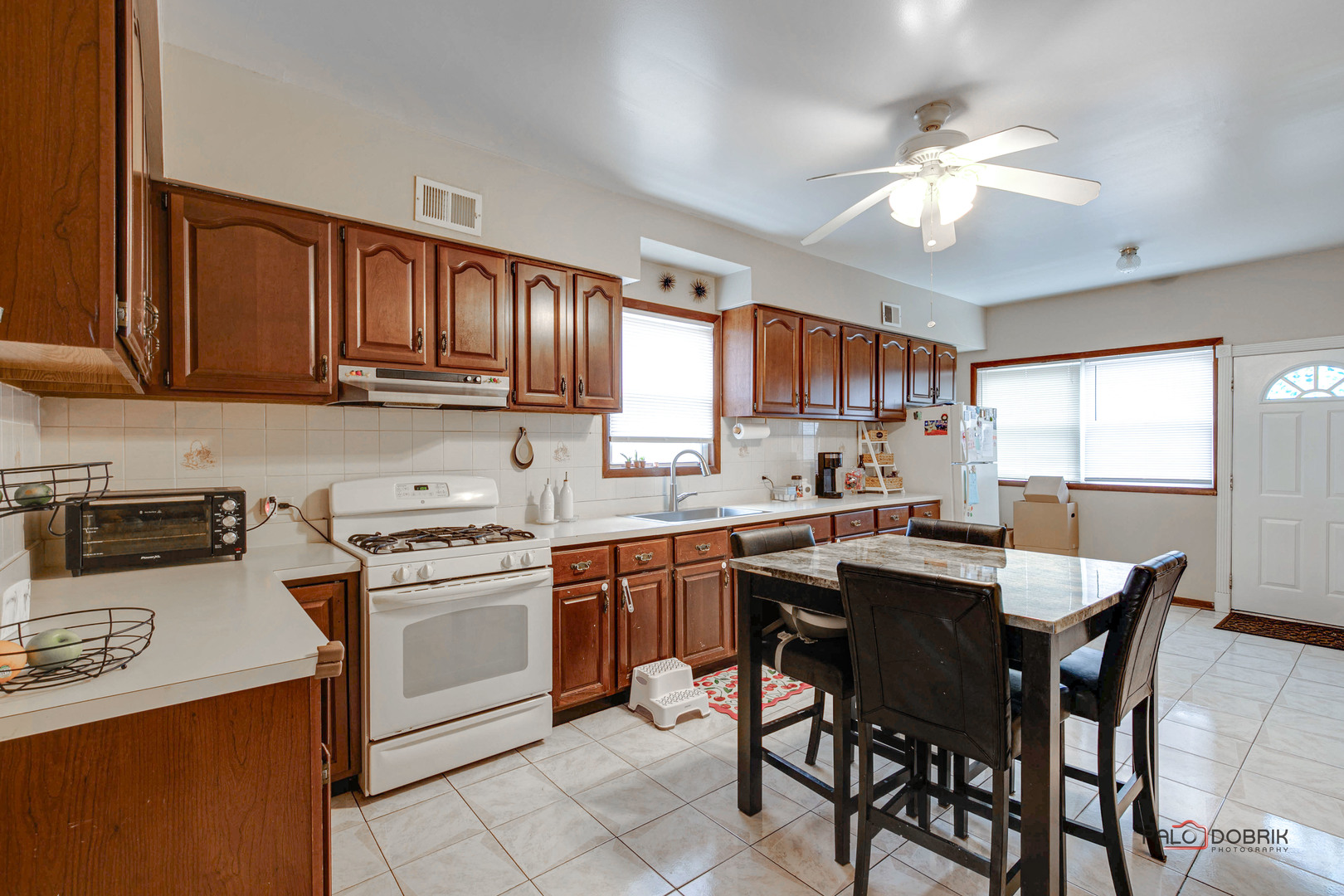 47 Prairie Avenue, Unit 1 Highwood, IL 60040 - Photo 10 of 20 a kitchen with a stove a sink a dining table and chairs