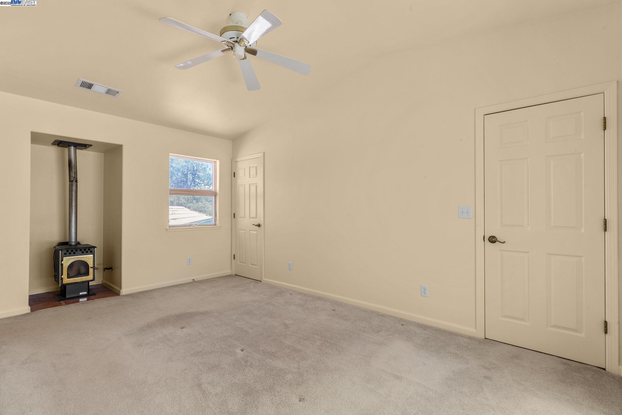 59480 Mines Road Livermore, CA 94550 - Photo 26 of 44 Upstairs primary bedroom, high ceiling fan, closet doors and closet that spans the full width of the room