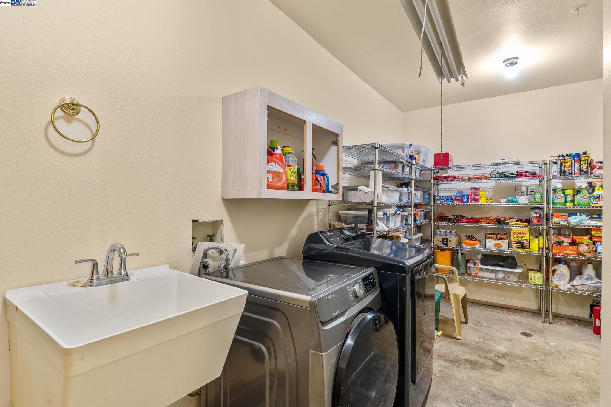 59480 Mines Road Livermore, CA 94550 - Photo 40 of 44 Pantry/mudroom sink, washer, dryer, shelving; this room has concrete floor with two floor drains