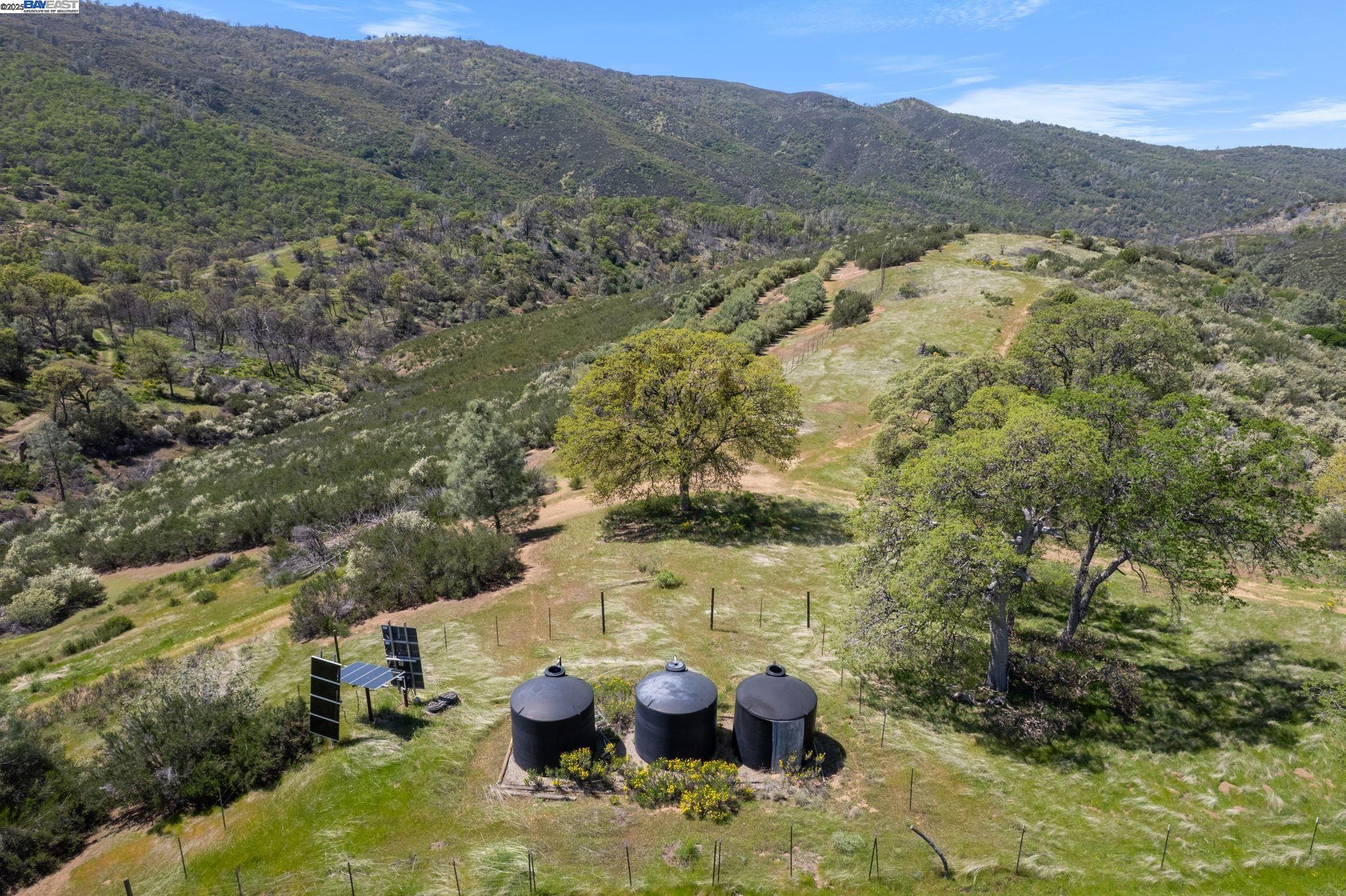 59480 Mines Road Livermore, CA 94550 - Photo 9 of 44 Orchard water tanks with solar panels for the pump. The tank area is fenced. The well is separate from the domestic water well