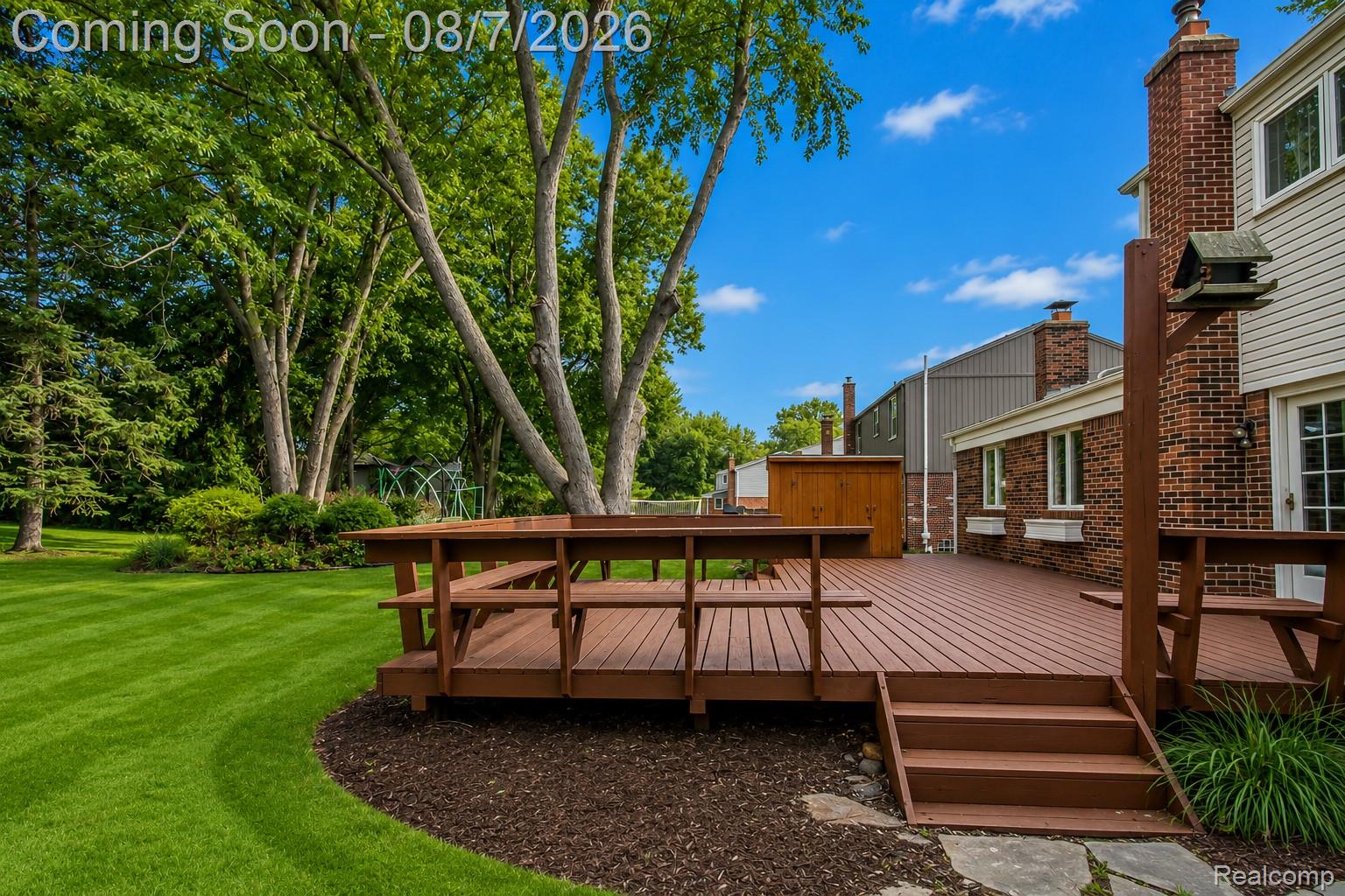 3149 Tamarron Drive Rochester, MI 48309 - Photo 43 of 48 Large outdoor deck with built-in bench seating and steps down to the garden beds