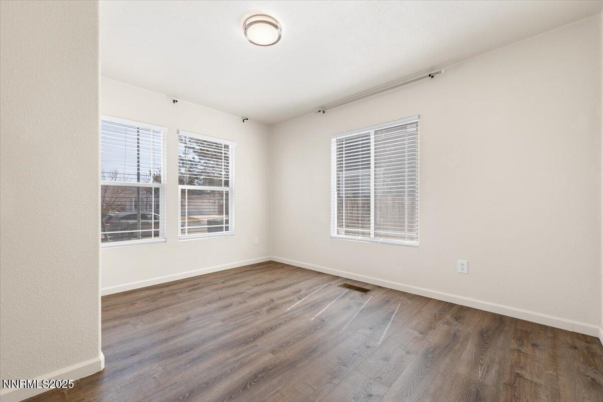 7753 Tulear Street Reno, NV 89506 - Photo 16 of 38 an empty room with wooden floor and windows