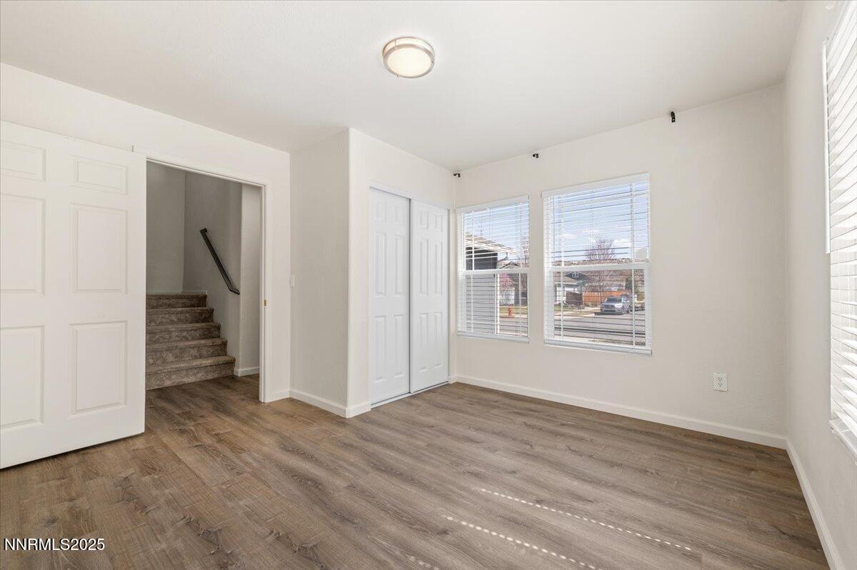 7753 Tulear Street Reno, NV 89506 - Photo 17 of 38 a view of empty room with wooden floor and fan