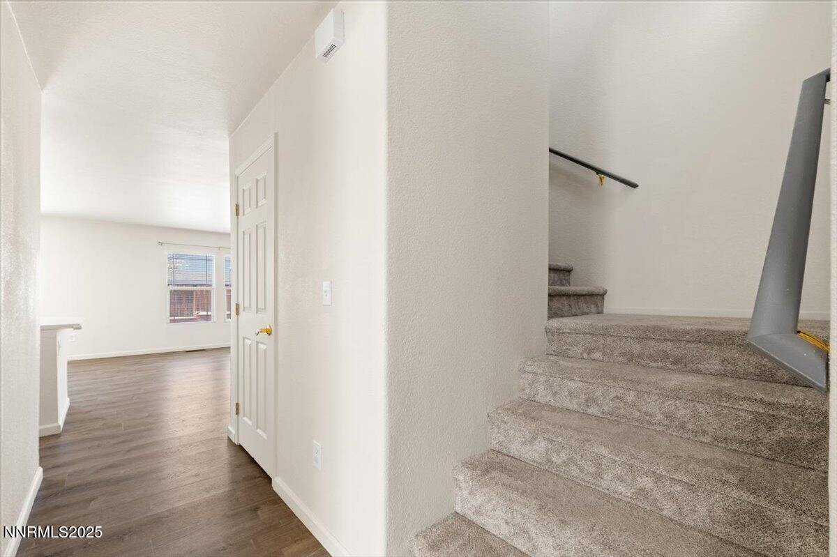 7753 Tulear Street Reno, NV 89506 - Photo 18 of 38 a view of a hallway with wooden floor