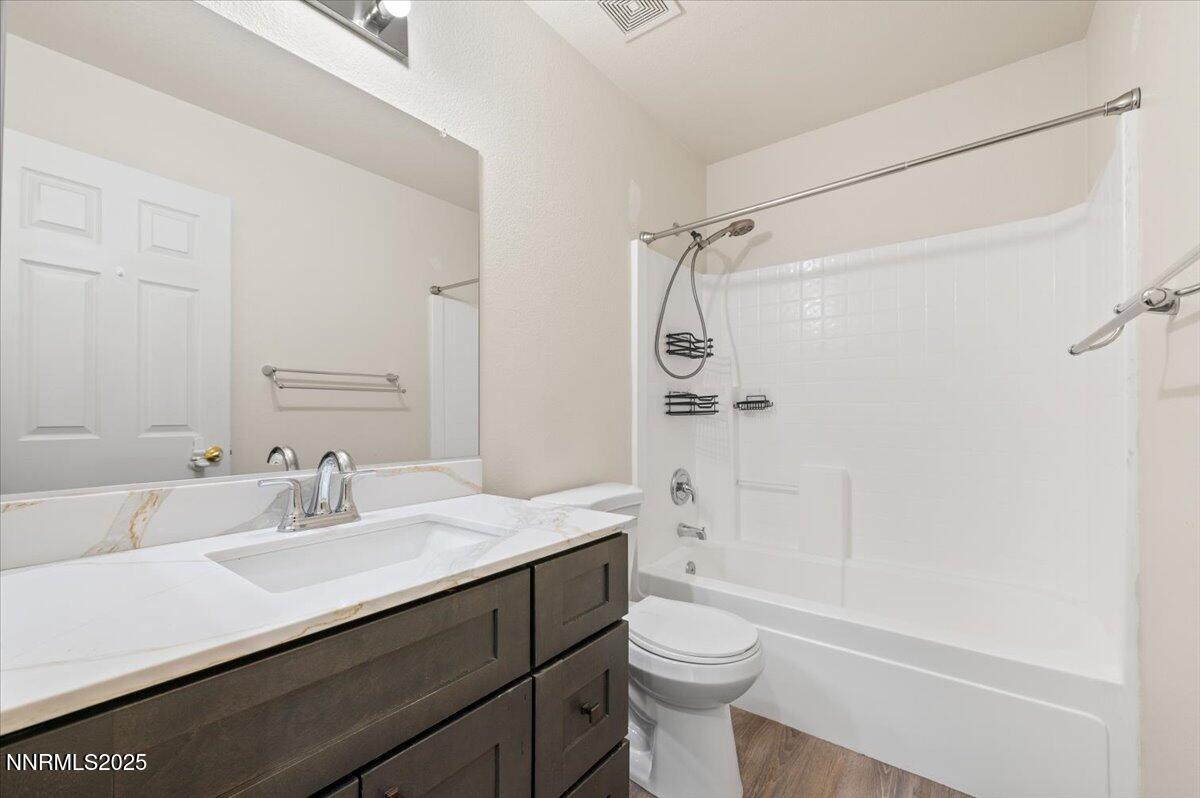7753 Tulear Street Reno, NV 89506 - Photo 32 of 38 a bathroom with a sink a toilet and shower