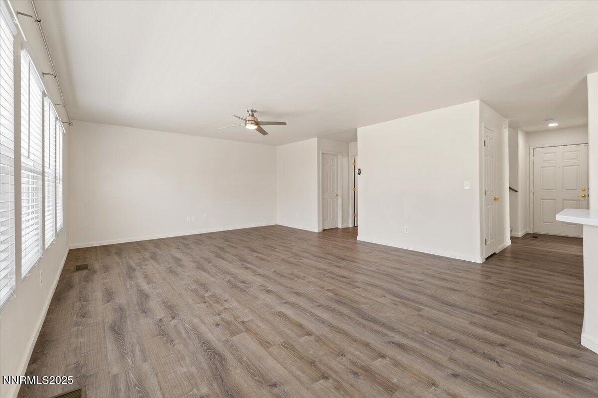 7753 Tulear Street Reno, NV 89506 - Photo 6 of 38 an empty room with wooden floor and windows