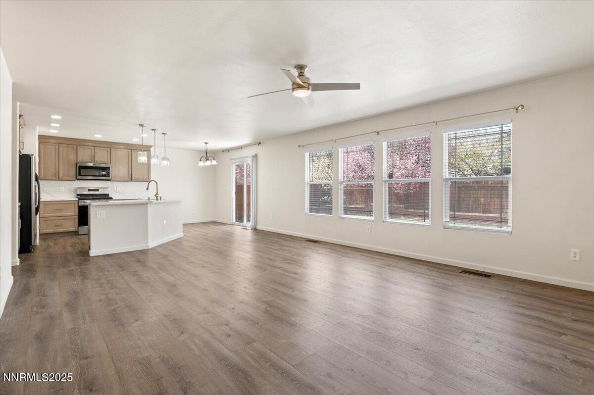 7753 Tulear Street Reno, NV 89506 - Photo 8 of 38 a view of a kitchen with a stove cabinets and wooden floor