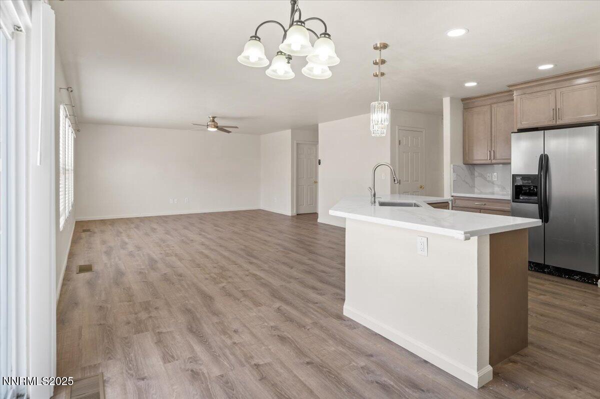 7753 Tulear Street Reno, NV 89506 - Photo 10 of 38 a kitchen with kitchen island white cabinets and stainless steel appliances