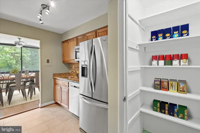 a kitchen with cabinets and stainless steel appliances