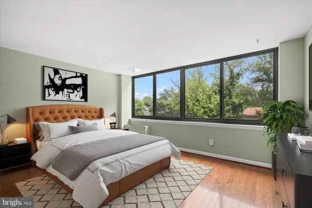 a bedroom with a large bed and a large window