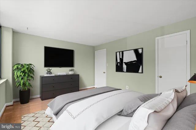 a bedroom with a bed and a flat screen tv