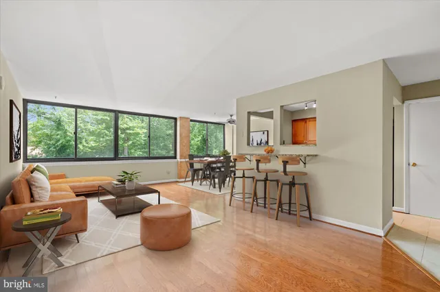 a living room with furniture and a floor to ceiling window