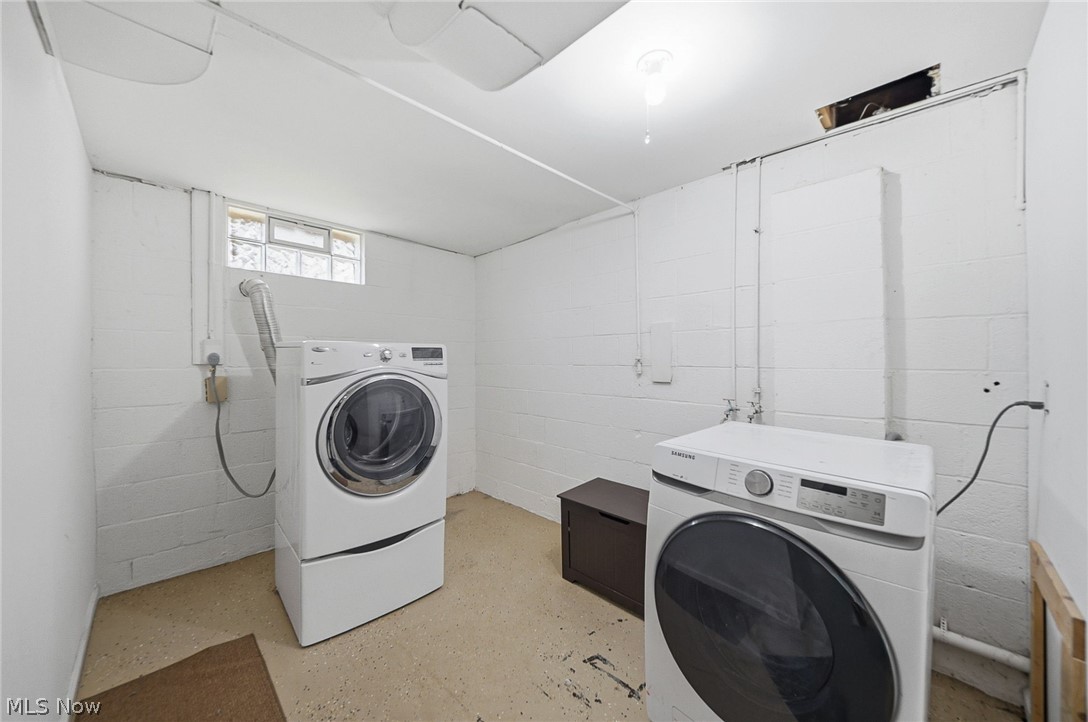 3905 Kent Road Stow, OH 44224 - Photo 34 of 45 Laundry area featuring finished concrete flooring and washer and clothes dryer