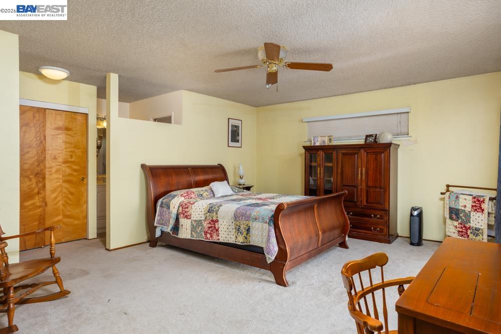 4591 Edwards Lane Castro Valley, CA 94546 - Photo 18 of 44 a bedroom with a bed and a chandelier