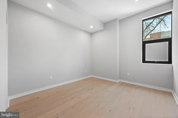 an empty room with windows and closet