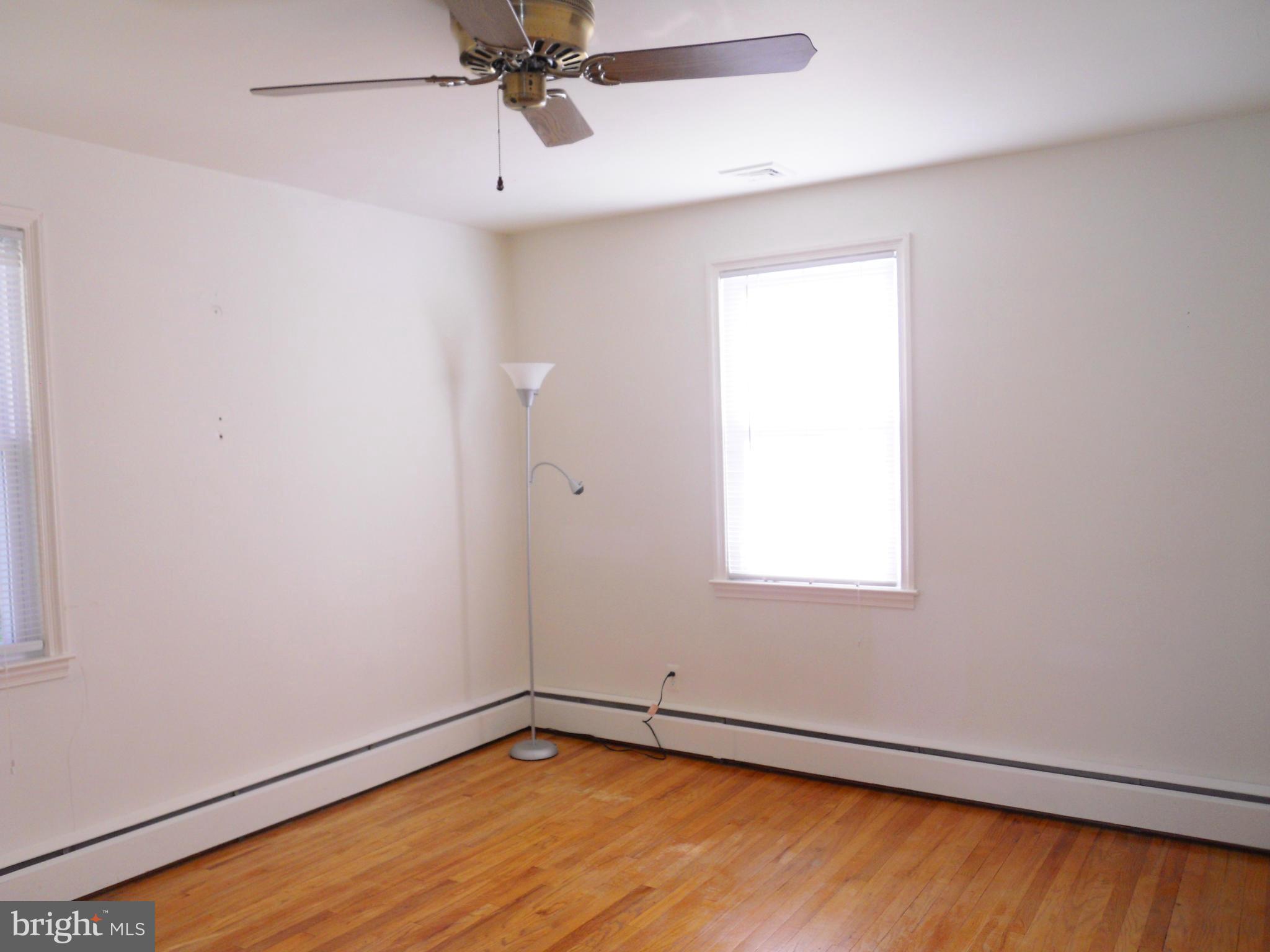 7311 Knollwood Road Baltimore, MD 21286 - Photo 13 of 30 an empty room with a window and a ceiling fan