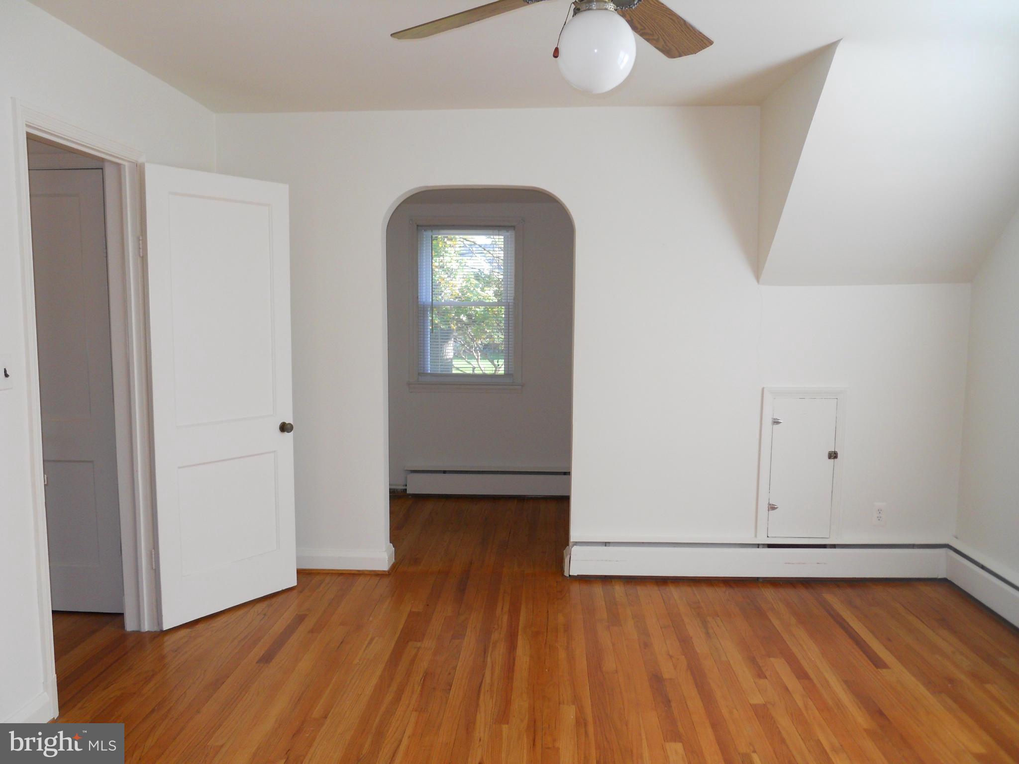 7311 Knollwood Road Baltimore, MD 21286 - Photo 18 of 30 an empty room with wooden floor closet and windows