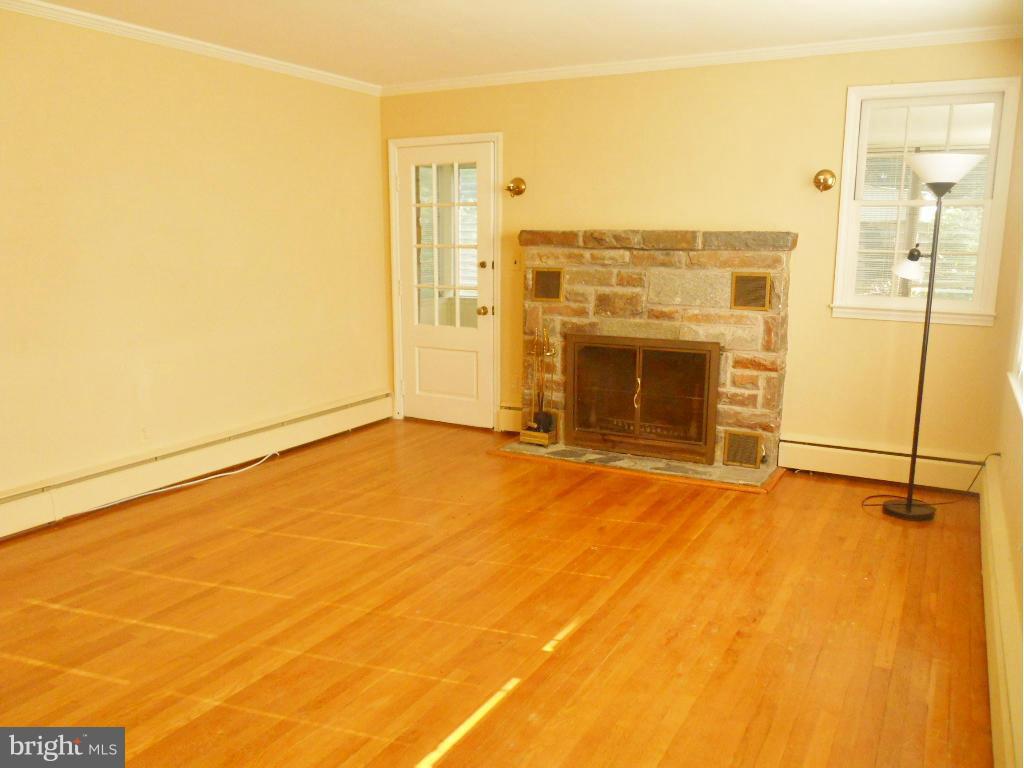 7311 Knollwood Road Baltimore, MD 21286 - Photo 3 of 30 a view of an empty room with a fireplace