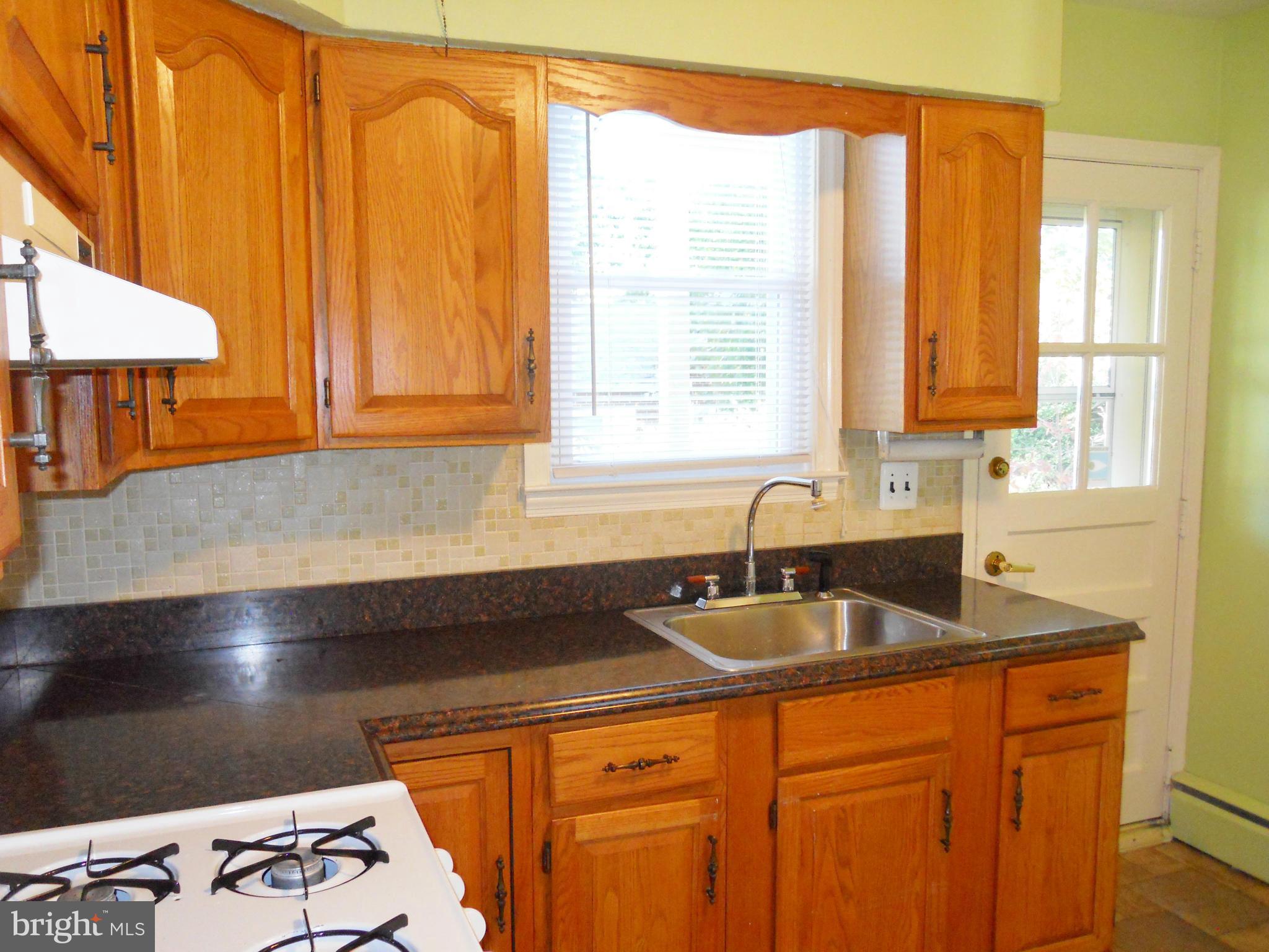 7311 Knollwood Road Baltimore, MD 21286 - Photo 9 of 30 a kitchen with stainless steel appliances granite countertop a sink and a cabinets