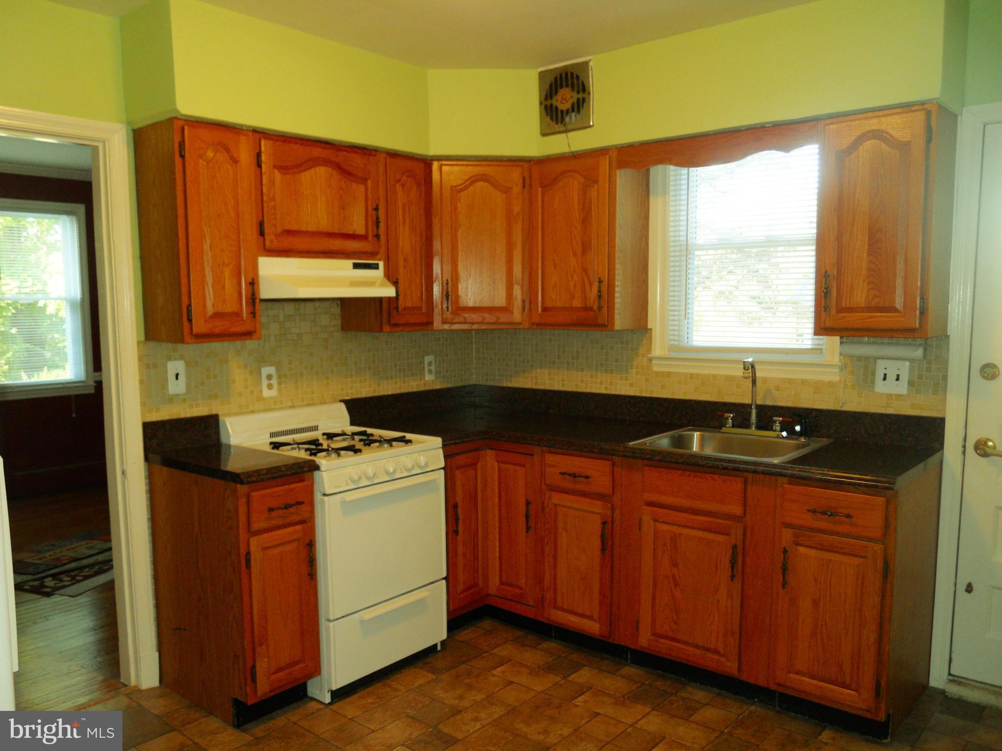 7311 Knollwood Road Baltimore, MD 21286 - Photo 10 of 30 a kitchen with a sink a stove and cabinets