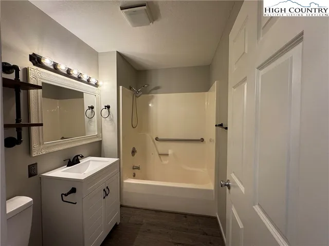 a bathroom with a tub sink and mirror