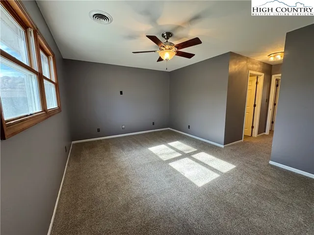 a view of a livingroom with a ceiling fan and window