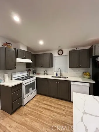 a kitchen with stainless steel appliances granite countertop a stove and a sink