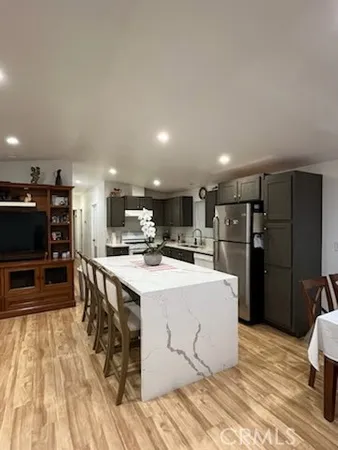 a kitchen with stainless steel appliances a refrigerator and a stove top oven