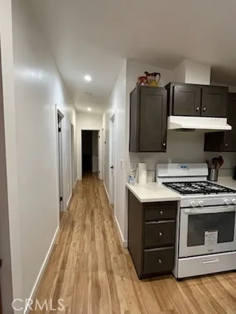 a kitchen with a stove and a refrigerator