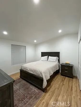 a bedroom with a bed and a night stand