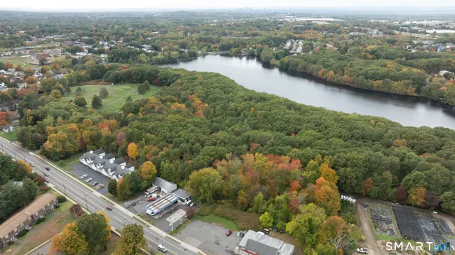 an aerial view of residential houses with outdoor space and river