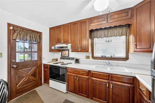 a kitchen with stainless steel appliances a sink stove and cabinets