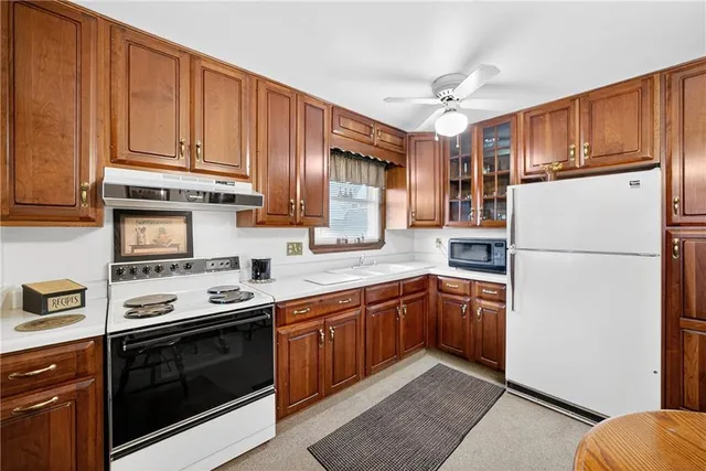 a kitchen with stainless steel appliances granite countertop a refrigerator stove a sink dishwasher and microwave oven