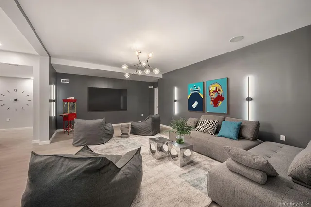 a living room with furniture and a chandelier