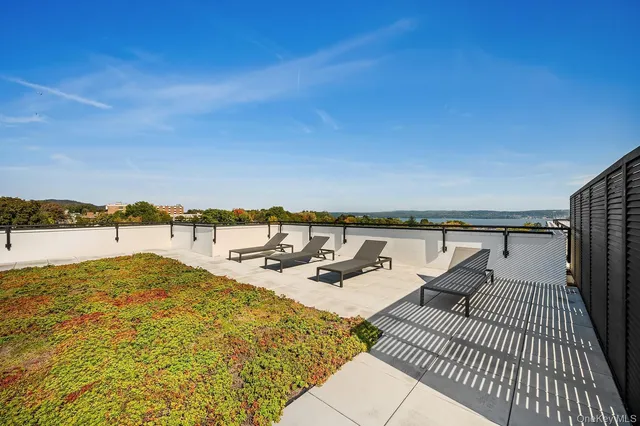 a view of swimming pool with outdoor seating and yard in the back