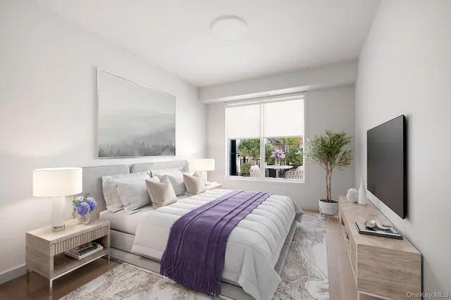 a bedroom with a bed tv and window