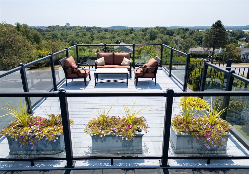 8 Goldfinch Way Ipswich, MA 01938 - Photo 8 of 41 a view of a chairs and table on the balcony