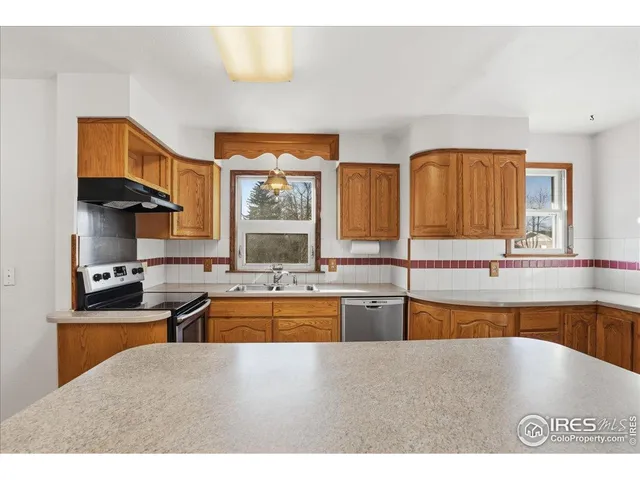 a kitchen with a sink cabinets and window