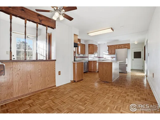 a view of an empty room with a ceiling fan