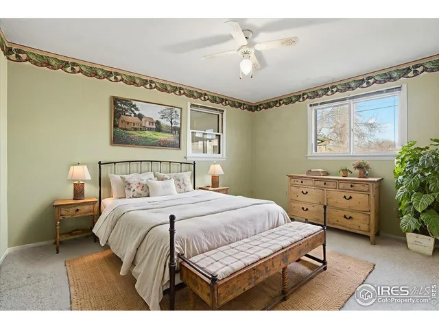 a bedroom with a bed and a painting on the wall