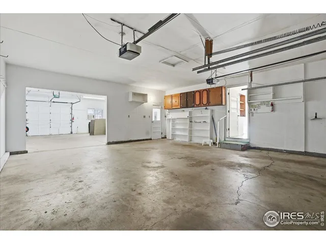 a kitchen with refrigerator and cabinets