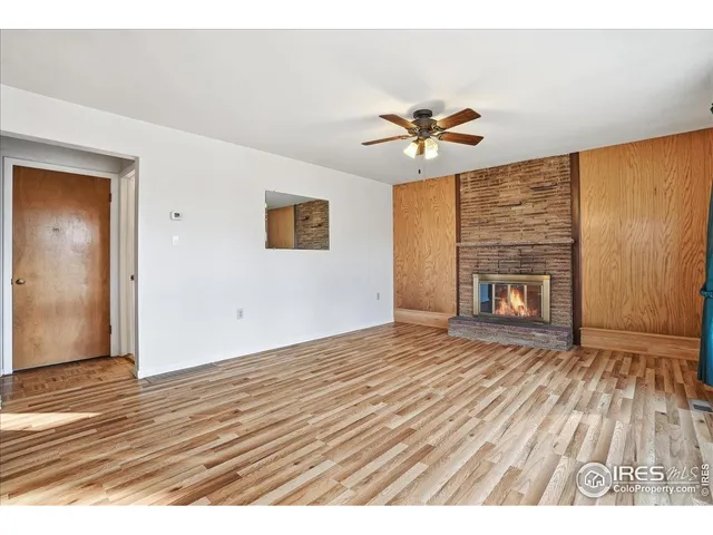 wooden floor in an empty room with a fireplace