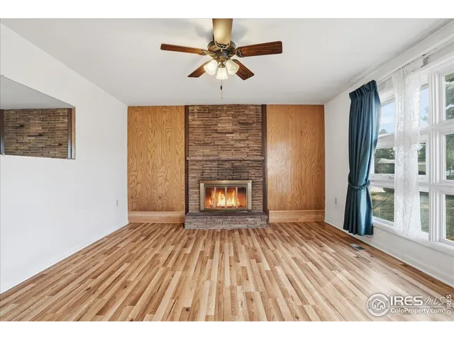a view interior of a house wooden floor a chandelier fan and windows