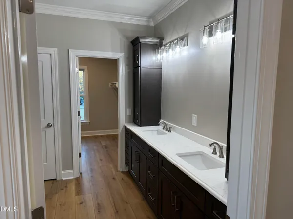 a bathroom with a double vanity sink and mirror