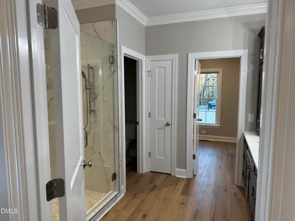 a view of a hallway with wooden floor