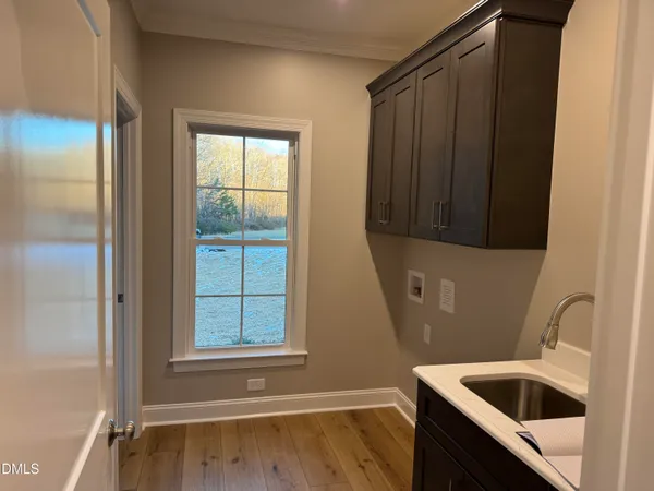 a bathroom with a sink a window and vanity
