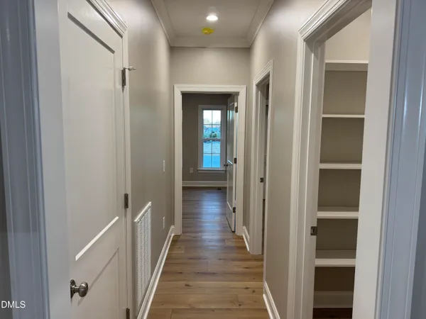 a view of a hallway with wooden floor and staircase