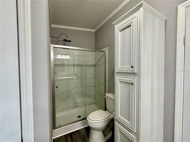 a bathroom with a toilet and a shower